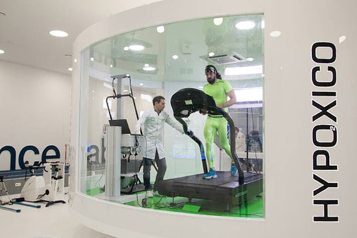 Man on treadmill being monitored by scientist