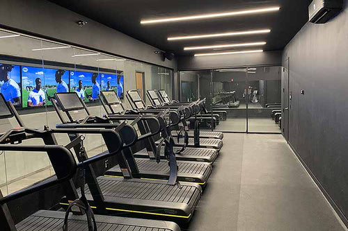Row of treadmills inside altitude chamber