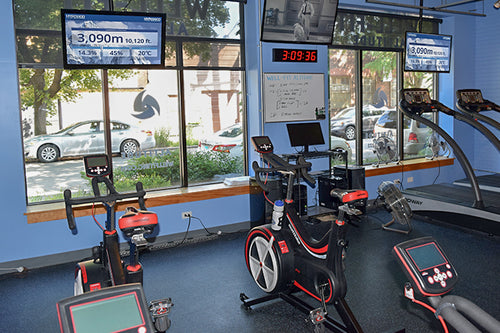 Empty altitude training gym with ellipticals and treadmills
