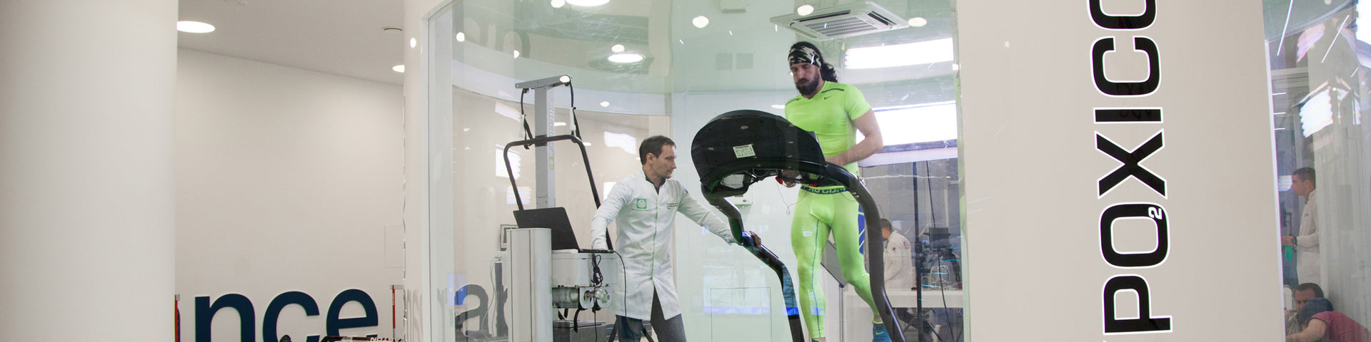 Man on treadmill being monitored by scientist
