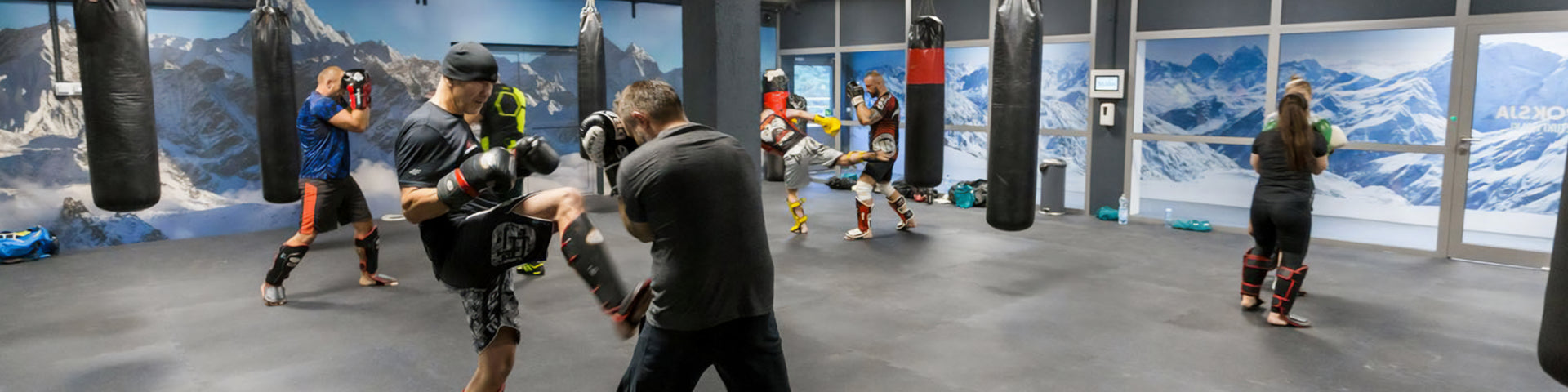 Multiple people practicing kickboxing in massive altitude chamber